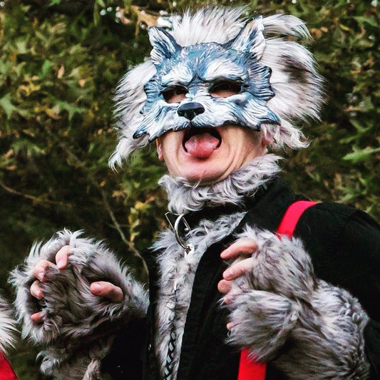 Customer wearing a white wolf masquerade mask in costume